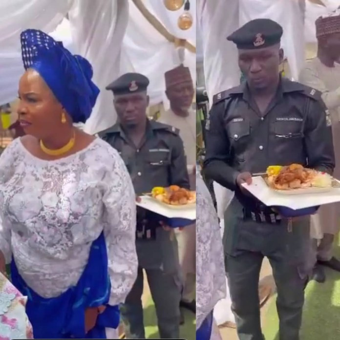 Police officer seen in viral video carrying female VIP's food