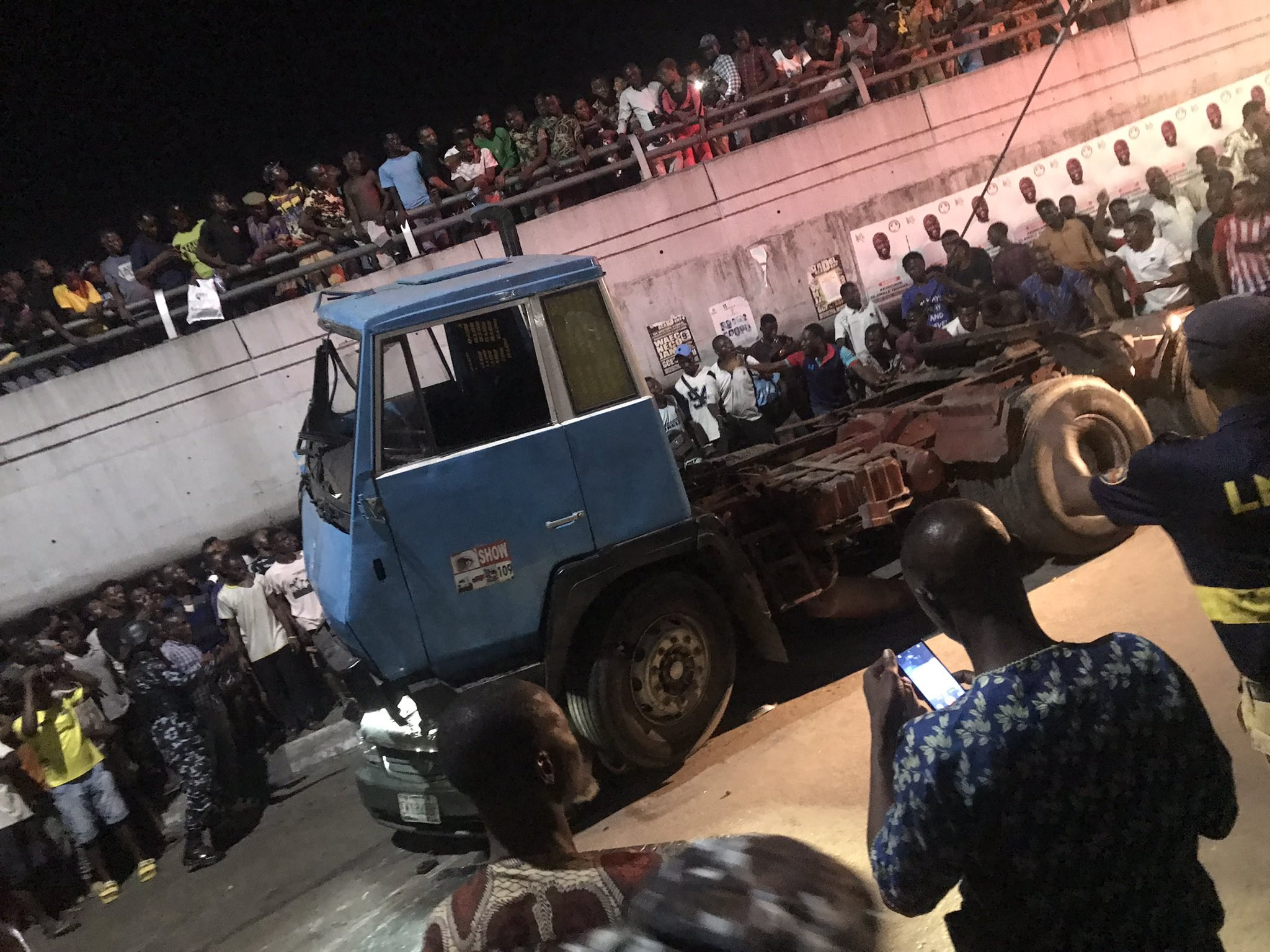 Many feared dead as trailer falls from bridge and lands on a car in Ojuelegba